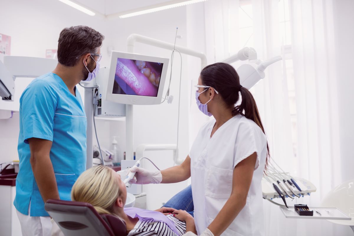 Dentist reviewing digital dental X-rays as part of a comprehensive dental exam in Guelph