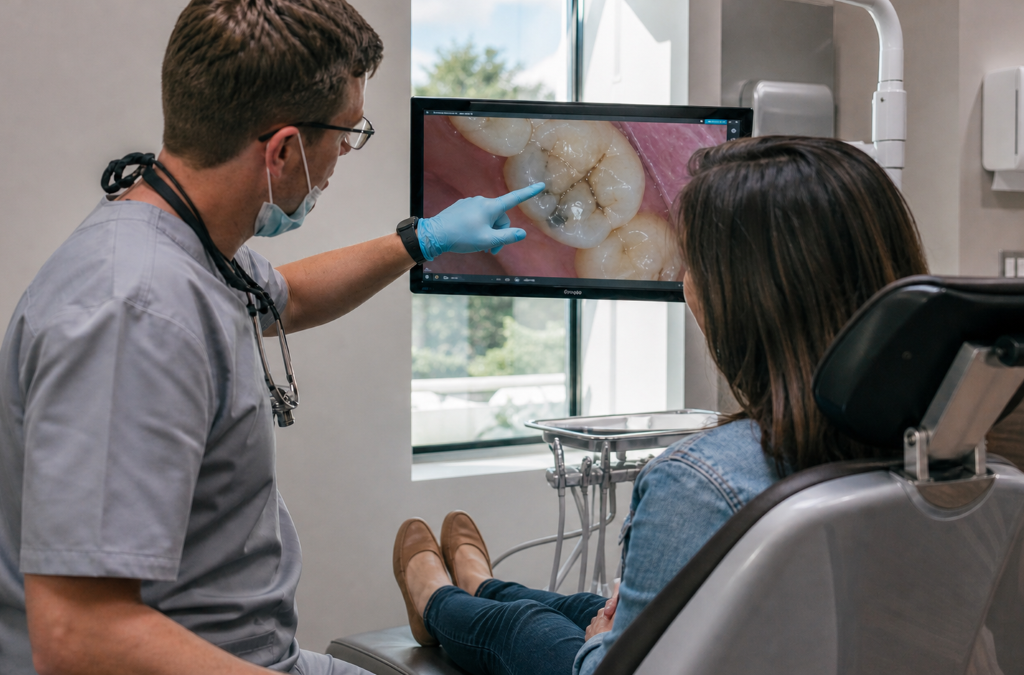 Tooth Filling at Aroma Dental in Humble, TX: a dentist placing a shade matched composite tooth filling in a prepared cavity