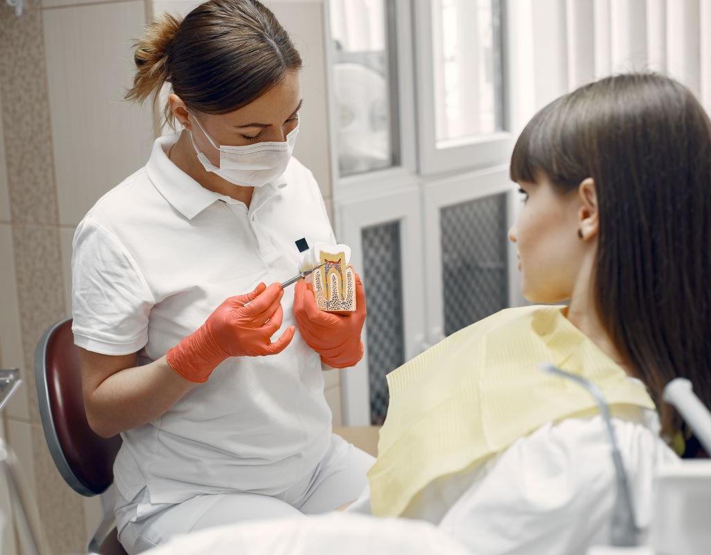 Root Canal Treatment in Humble, TX | Aroma Dental Root Canal Treatment at Aroma Dental in Humble, TX: a dentist performing comfortable root canal treatment on a numbed patient